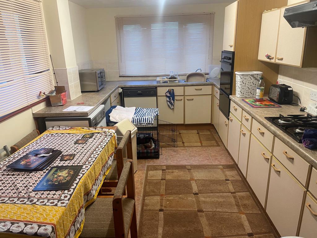 Lot: 146 - FREEHOLD PROPERTY WITH ADDITIONAL LAND - Kitchen with fitted units and table
